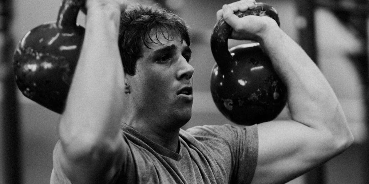 Crossfit athlete working with kettlebells